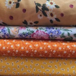 Yellow bundle of floral fabric for sewing
